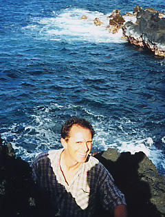 Neil climbing all over the lava cliffs