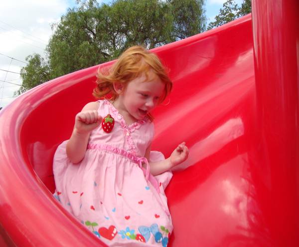 Sophie playing on the slide