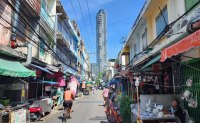 Old traditional alley overshadowed by modern Bangkok