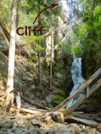 Neil at waterfall with cliff