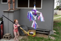 Sophie taking a swing at the piñata
